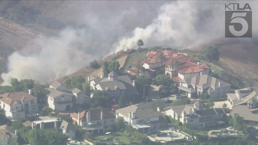 West Hills brush fire threatens a neighborhood