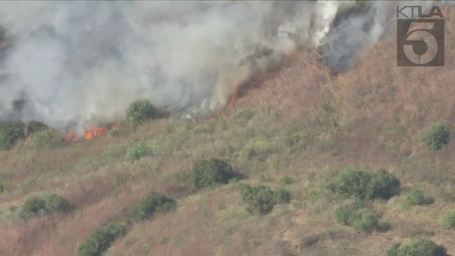 West Hills brush fire threatens a neighborhood