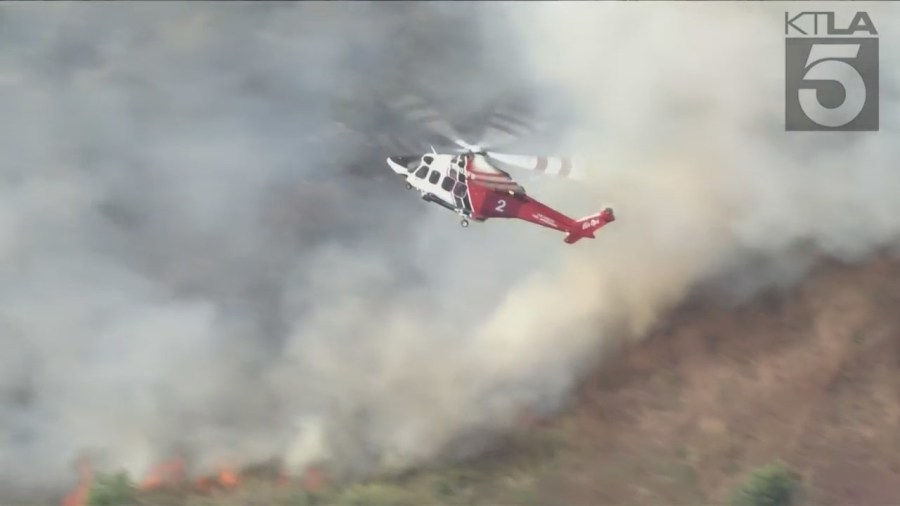 West Hills brush fire threatens a neighborhood