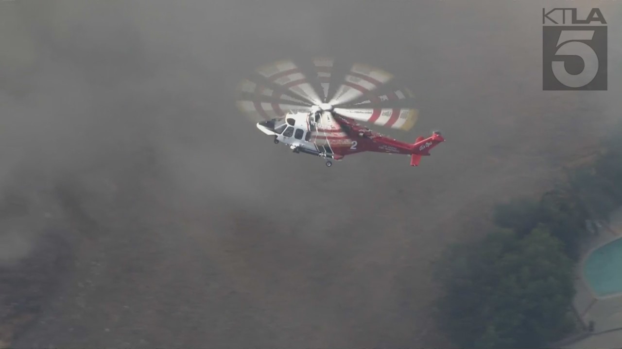 West Hills brush fire threatens a neighborhood