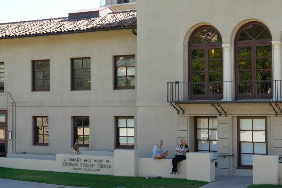 Students sit outside the Freeman College Union building at Occidental College campus in Los Angeles, Thursday, July 27, 2023. Occidental College is the latest school to end legacy admissions in the wake of a Supreme Court decision removing race from admissions decisions. (AP Photo/Damian Dovarganes)