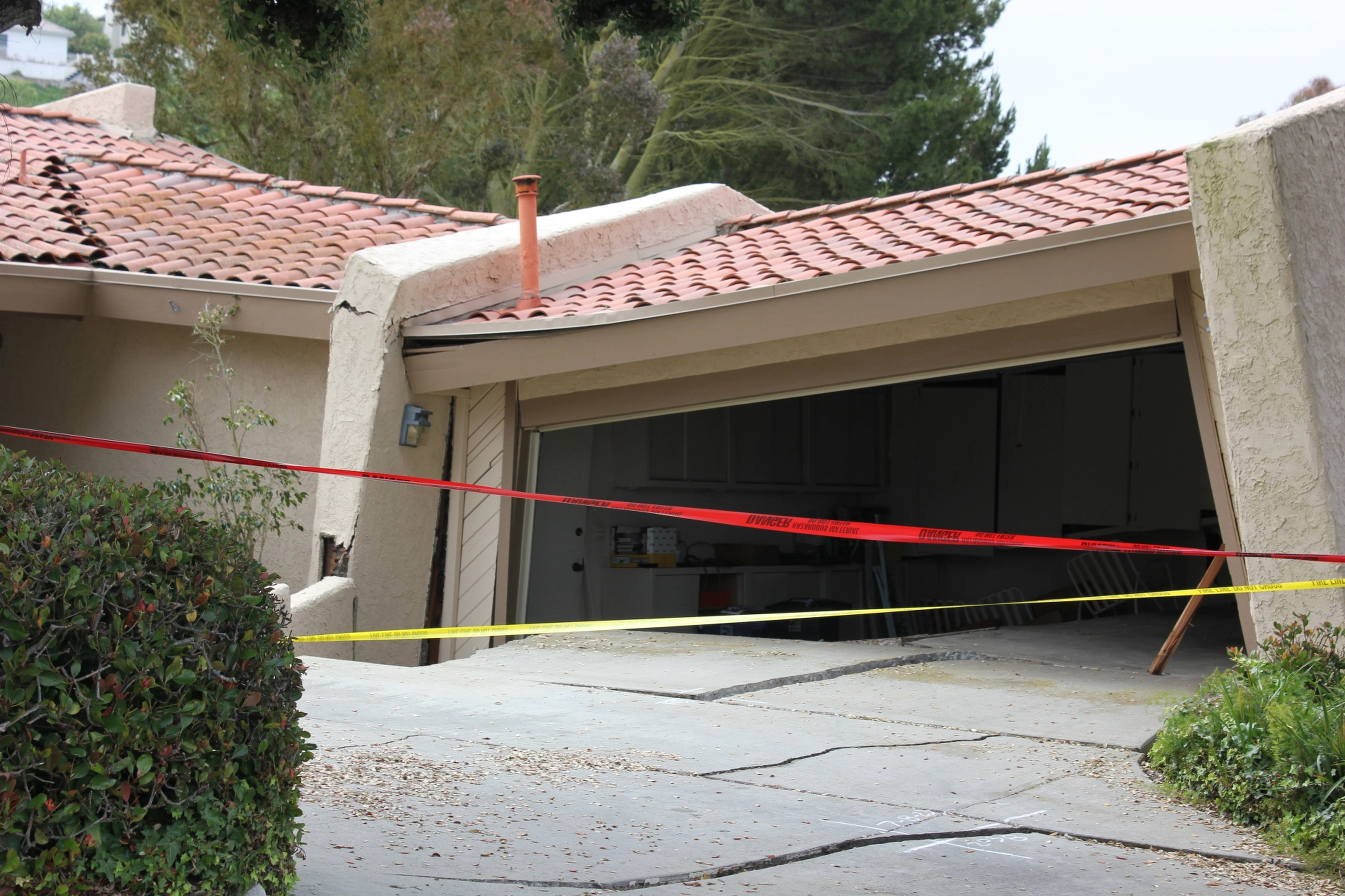 A house in Rolling Hills Estates is severely damaged after a landslide on the Palos Verdes Peninsula in Los Angeles County early July 9, 2023. (Michael Hixon/The Orange County Register via AP)