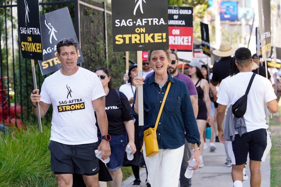 Annette Bening walks on a picket line outside Netflix studios on Tuesday, July 25, 2023, in Los Angeles. The actors strike comes more than two months after screenwriters began striking in their bid to get better pay and working conditions. (AP Photo/Chris Pizzello)