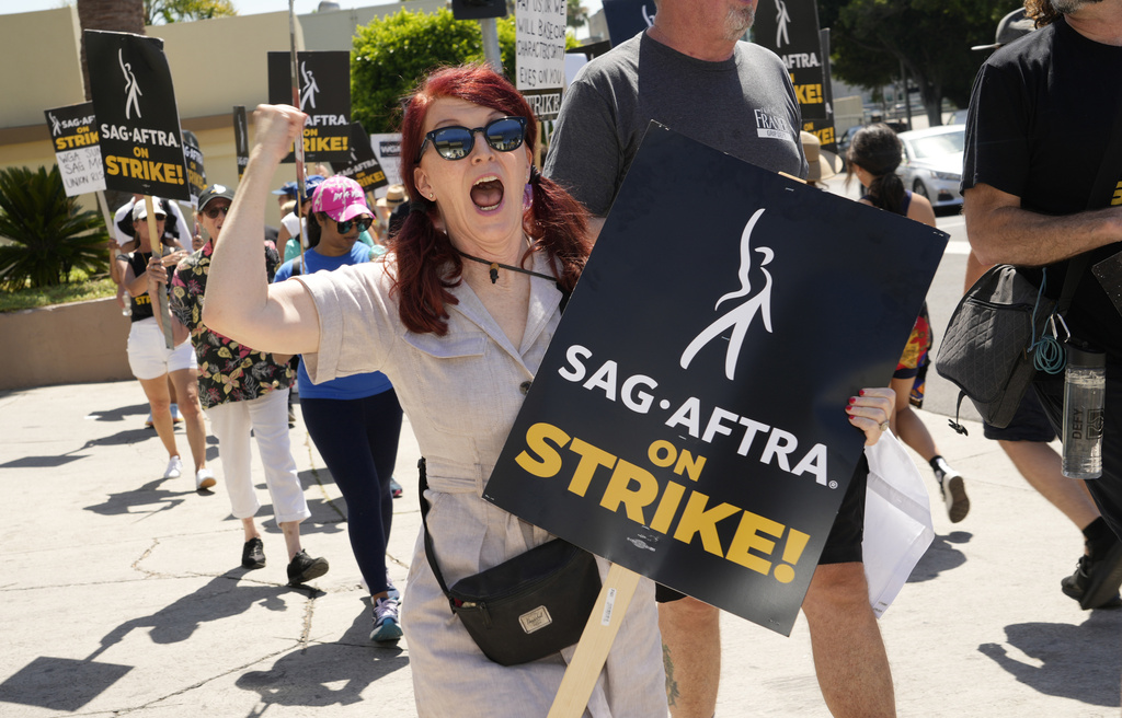 Kate Flannery appears on a picket line outside Paramount studios on Wednesday, July 26, 2023, in Los Angeles. The actors strike comes more than two months after screenwriters began striking in their bid to get better pay and working conditions. (AP Photo/Chris Pizzello)