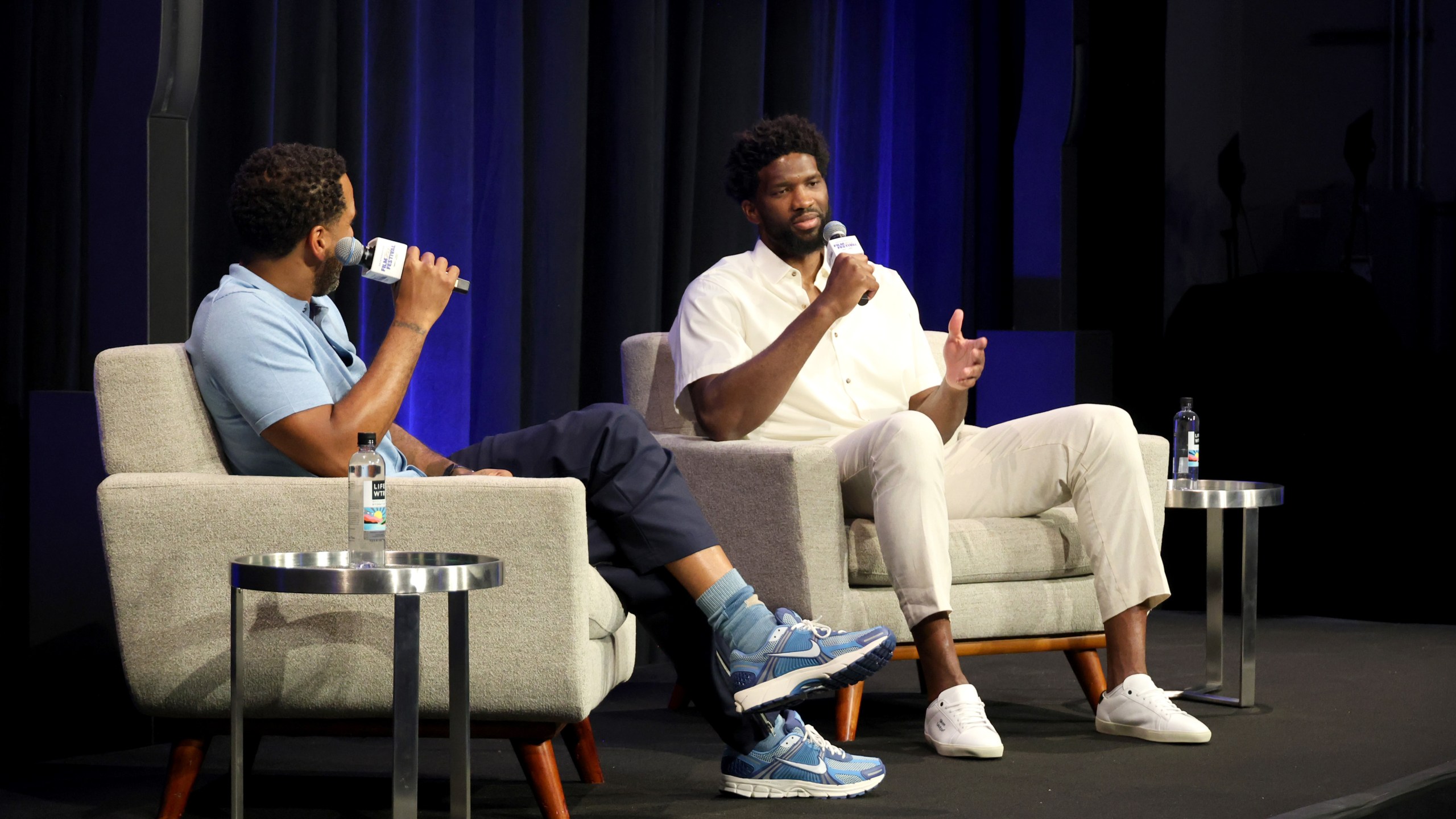 Maverick Carter and Joel Embiid on stage at the Uninterrupted Film Festival