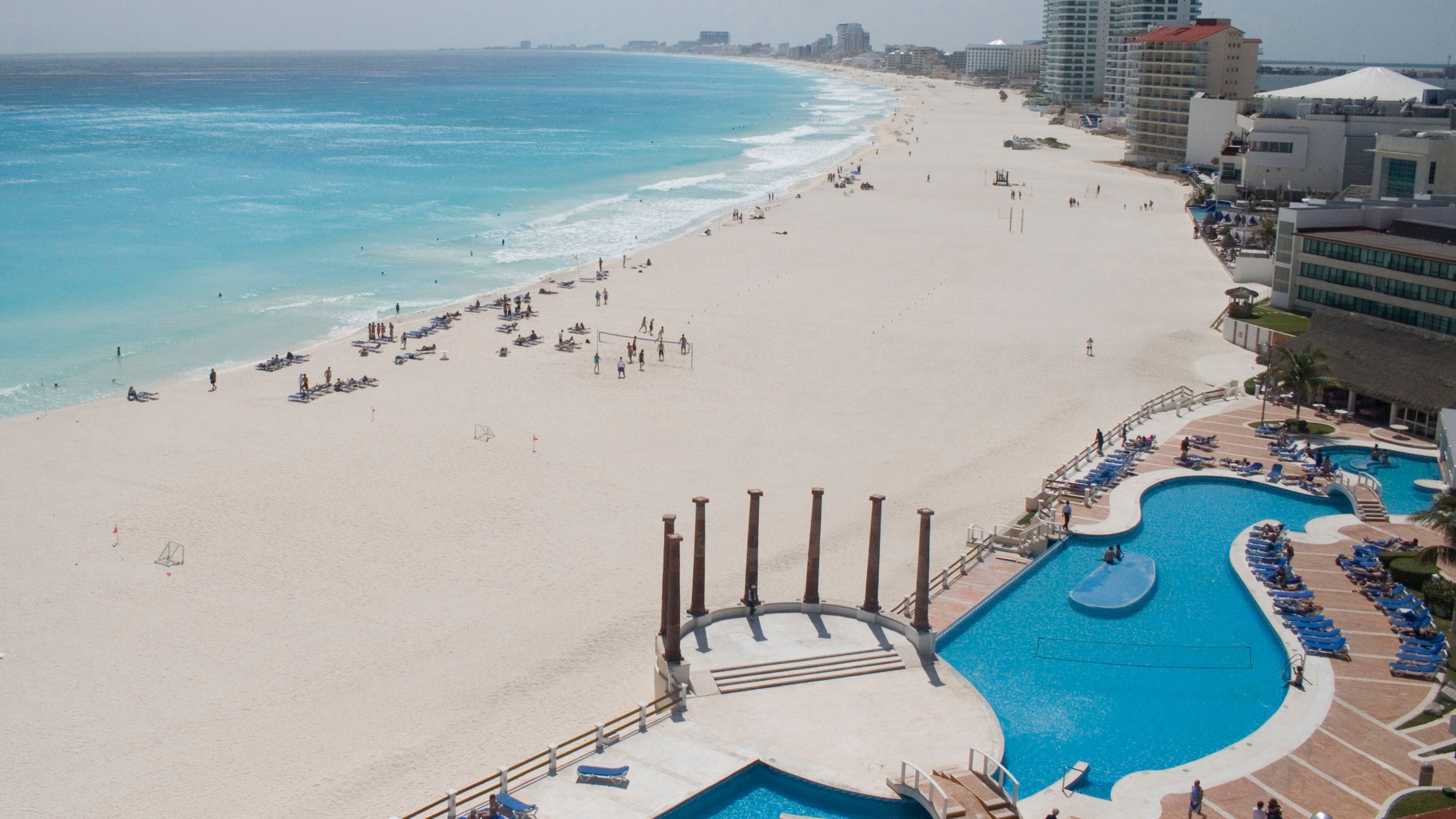 FILE - Tourists hang out on the Gaviota Azul beach in Cancun, Mexico, March 2, 2010. A four-day inspection raid targeting drugstores in Cancun, Playa del Carmen and Tulu resulted in the shuttering of 23 pharmacies at Caribbean coast resorts, six months after a report warned that the drug stores were offering foreigners pills they passed off as Oxycodone, Percocet and Adderall without prescriptions, the Navy Department said Tuesday, Aug. 8, 2023. (AP Photo/Israel Leal, File)