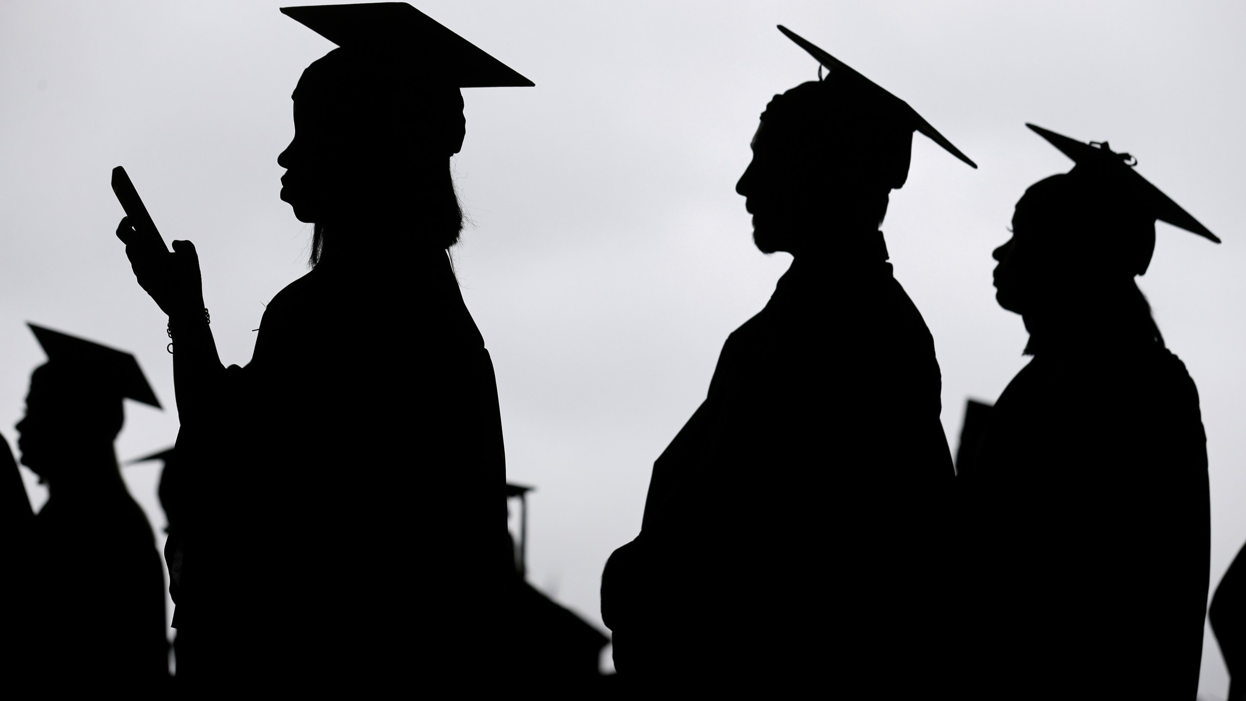 New graduates line up before the start of a community college commencement in East Rutherford, N.J. on May 17, 2018. (Seth Wenig/Associated Press)