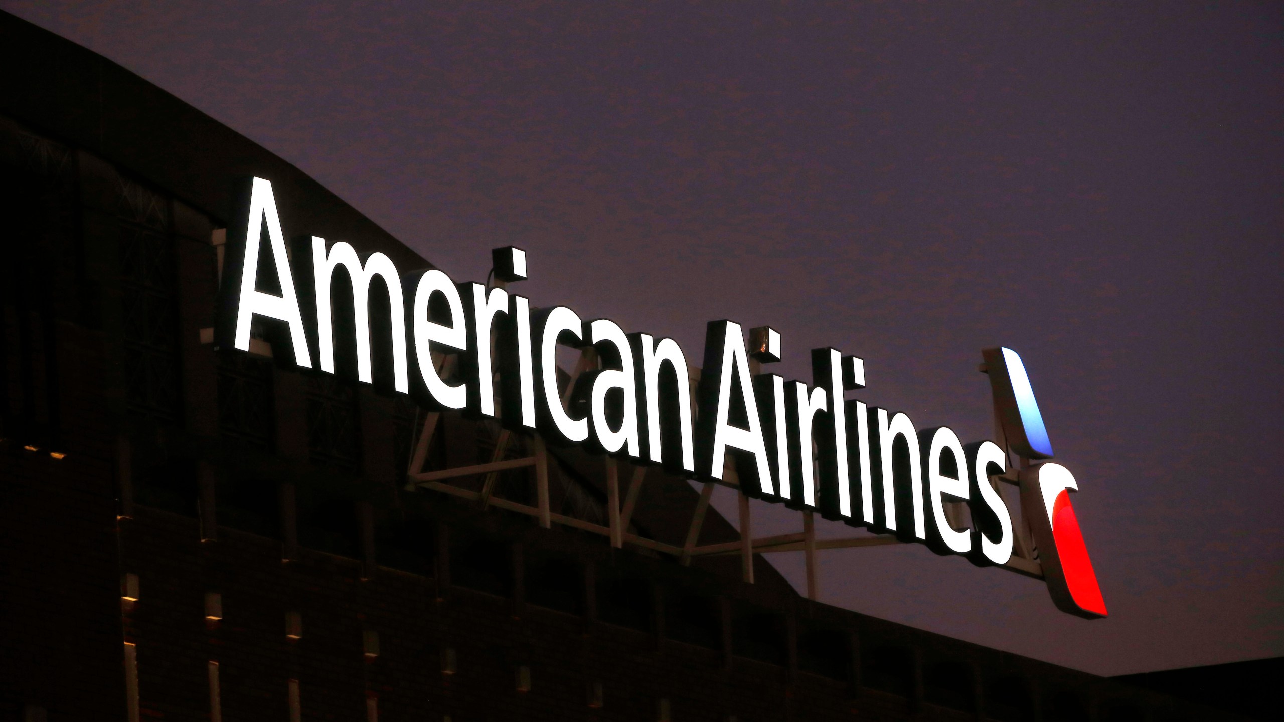 FILE - The American Airlines logo is seen atop the American Airlines Center in Dallas, Texas, Dec. 19, 2017. On Thursday, Aug. 17, 2023, American Airlines filed suit against Skiplagged Inc., a travel website that sells tickets that let people save money by exploiting a quirk in airline pricing, accusing the website of deception. It threatened to cancel every ticket that Skiplagged has sold. (AP Photo/Michael Ainsworth, File)