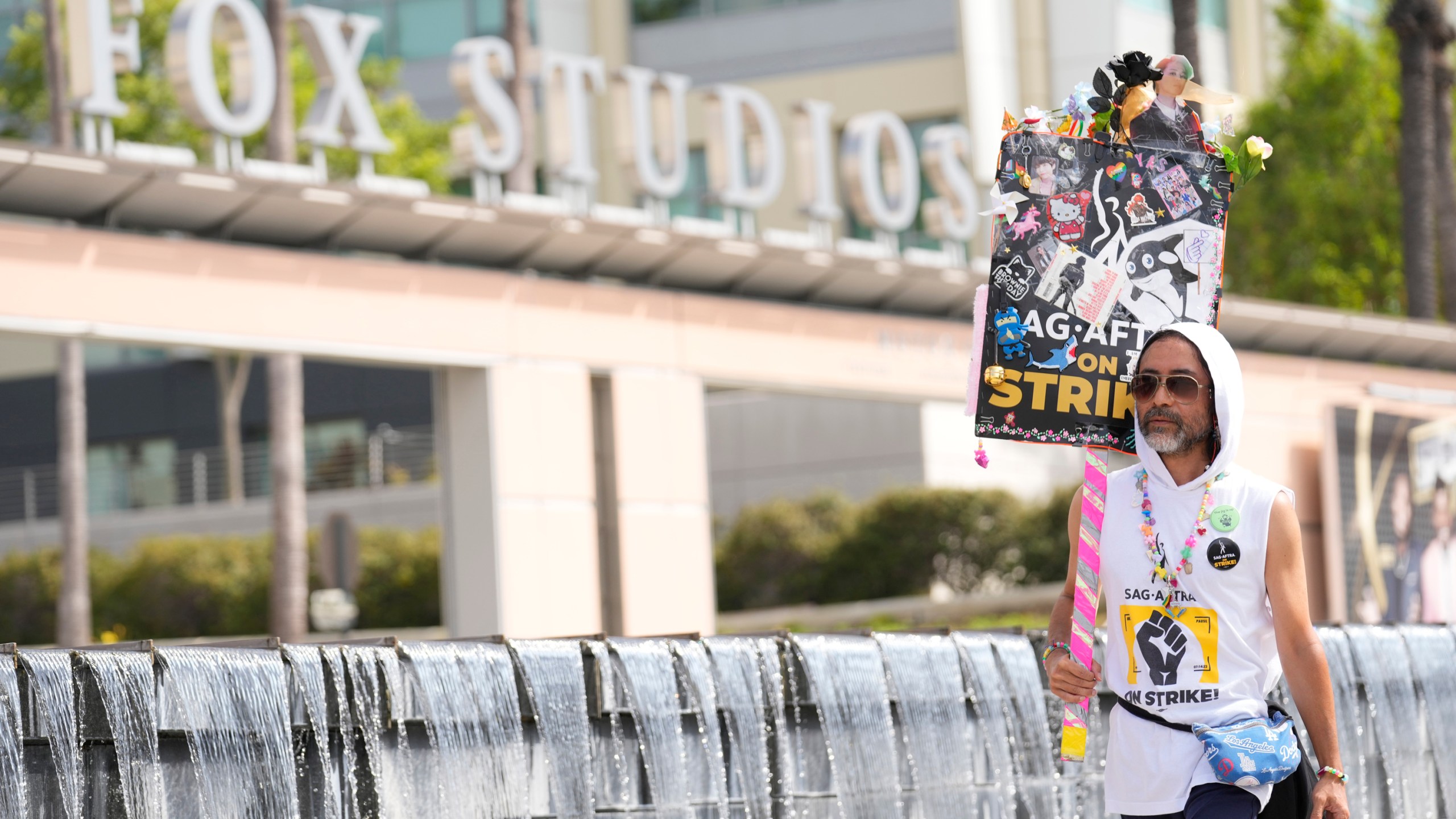 SAG-AFTRA member Newt Kane walks on a picket line outside Fox studios on Monday, Aug. 14, 2023, in Los Angeles. (AP Photo/Chris Pizzello)