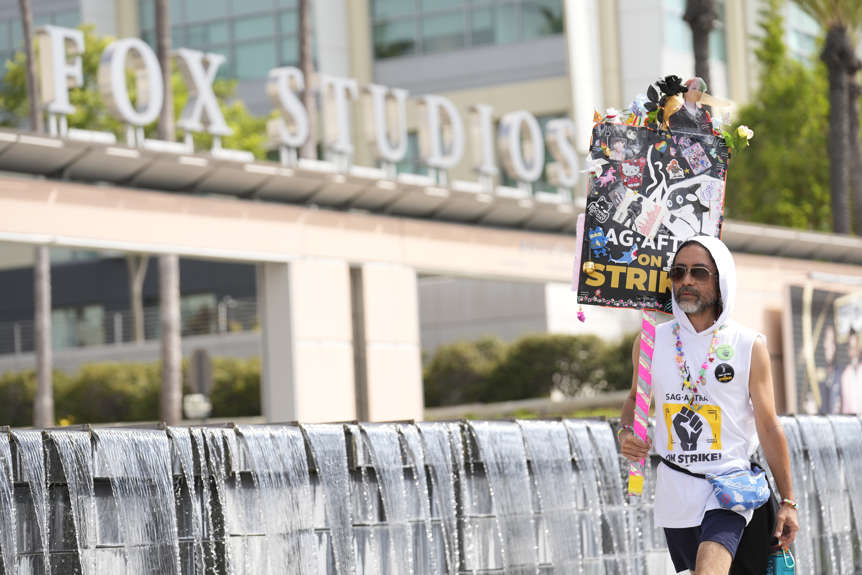 SAG-AFTRA member Newt Kane walks on a picket line outside Fox studios on Monday, Aug. 14, 2023, in Los Angeles. (AP Photo/Chris Pizzello)