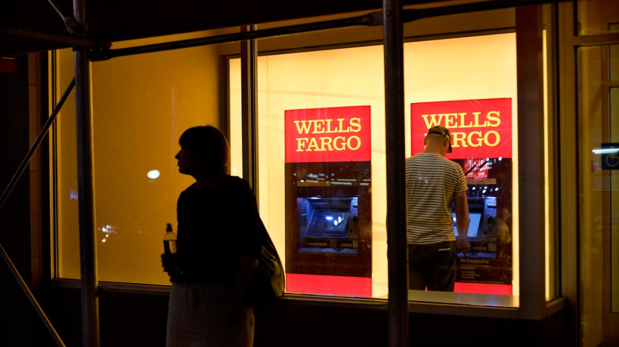 In this Sept. 21, 2016 file photo, a customer uses a Wells Fargo bank ATM. (AP Photo/Patrick Sison)