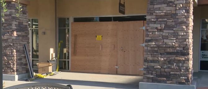 The boarded up front doors and windows of Rodeo Jewelers in La Verne, California after thieves crashed into the glass entryway on July 1, 2023. (KTLA)