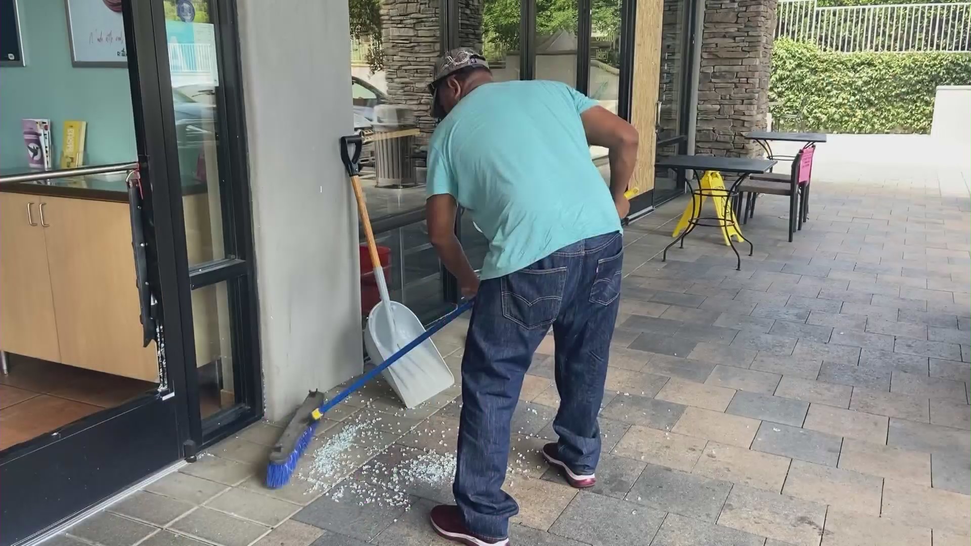 Business owners cleaning up after security cameras after a group of serial burglars after eight businesses were smashed in the Santa Clarita Valley on August 9, 2023. (KTLA)