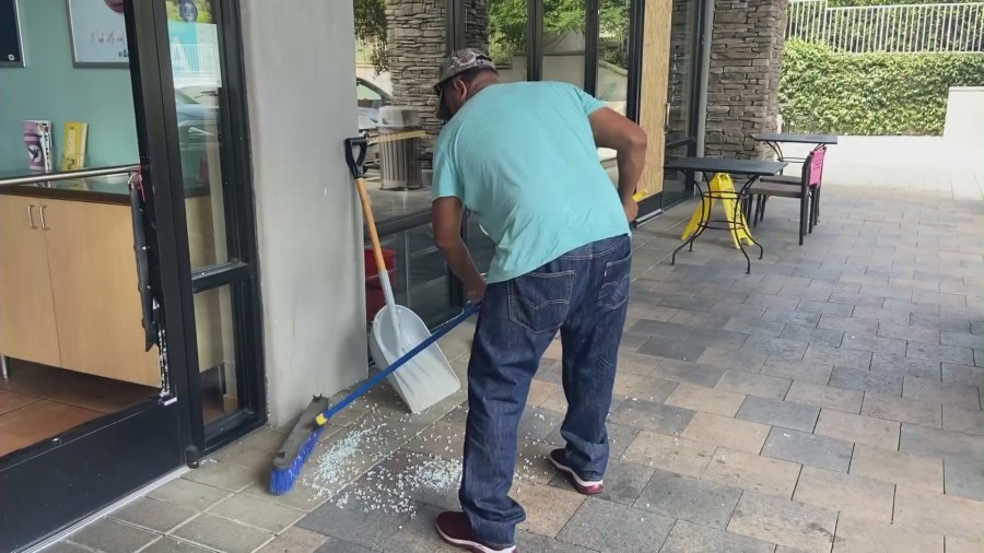 Business owners cleaning up after security cameras after a group of serial burglars after eight businesses were smashed in the Santa Clarita Valley on August 9, 2023. (KTLA)