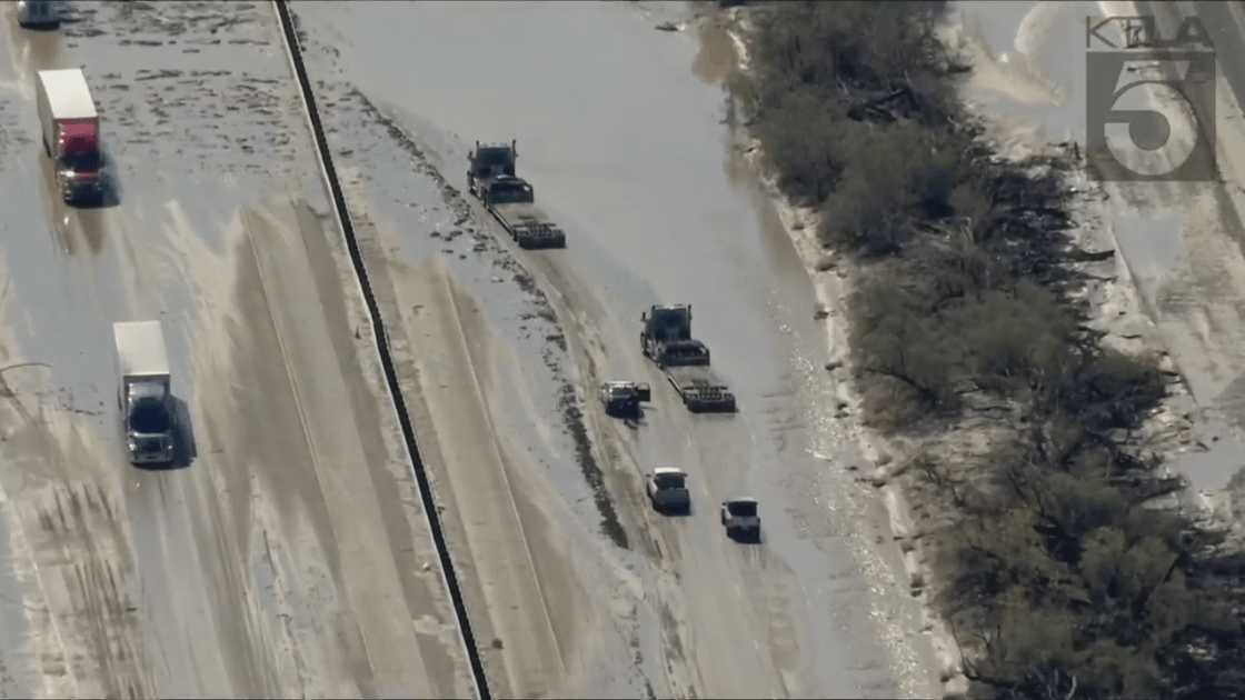 Trucks try to maneuver mud near Cathedral City on Aug. 21, 2023, a day after Tropical Storm Hilary slammed Southern California. (KTLA)