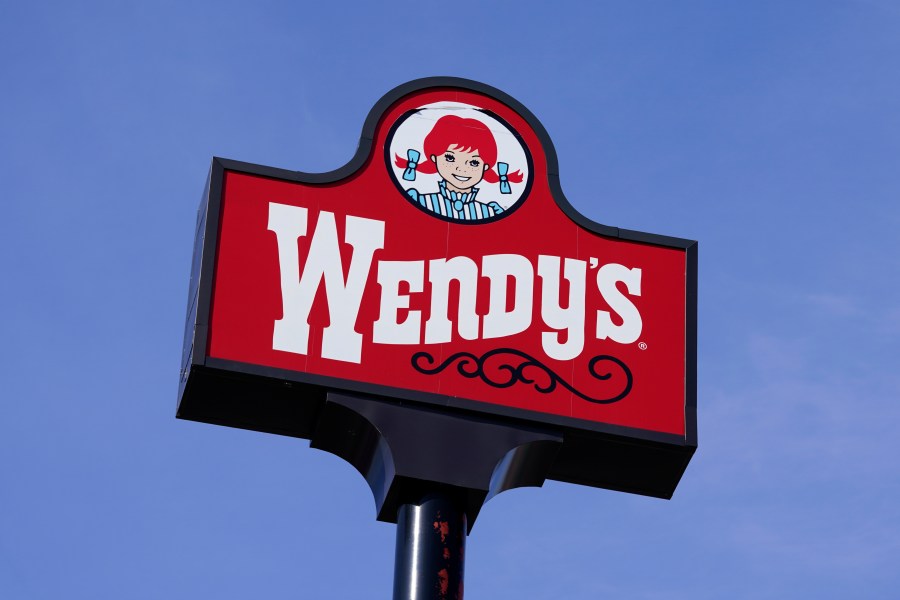 FILE - A sign stands over a Wendy's restaurant, Feb. 25, 2021, in Des Moines, Iowa. Food ads have long made their subjects look bigger, juicier and crispier than they are in person. But some consumers say those mouthwatering ads can cross the line into deception, and that’s leading to a growing number of lawsuits. Burger King is the latest company in the crosshairs. While the case against Burger King was filed in Miami, one of the attorneys who filed it has similar cases pending in New York against Wendy’s, McDonald’s and Taco Bell. (AP Photo/Charlie Neibergall, File)