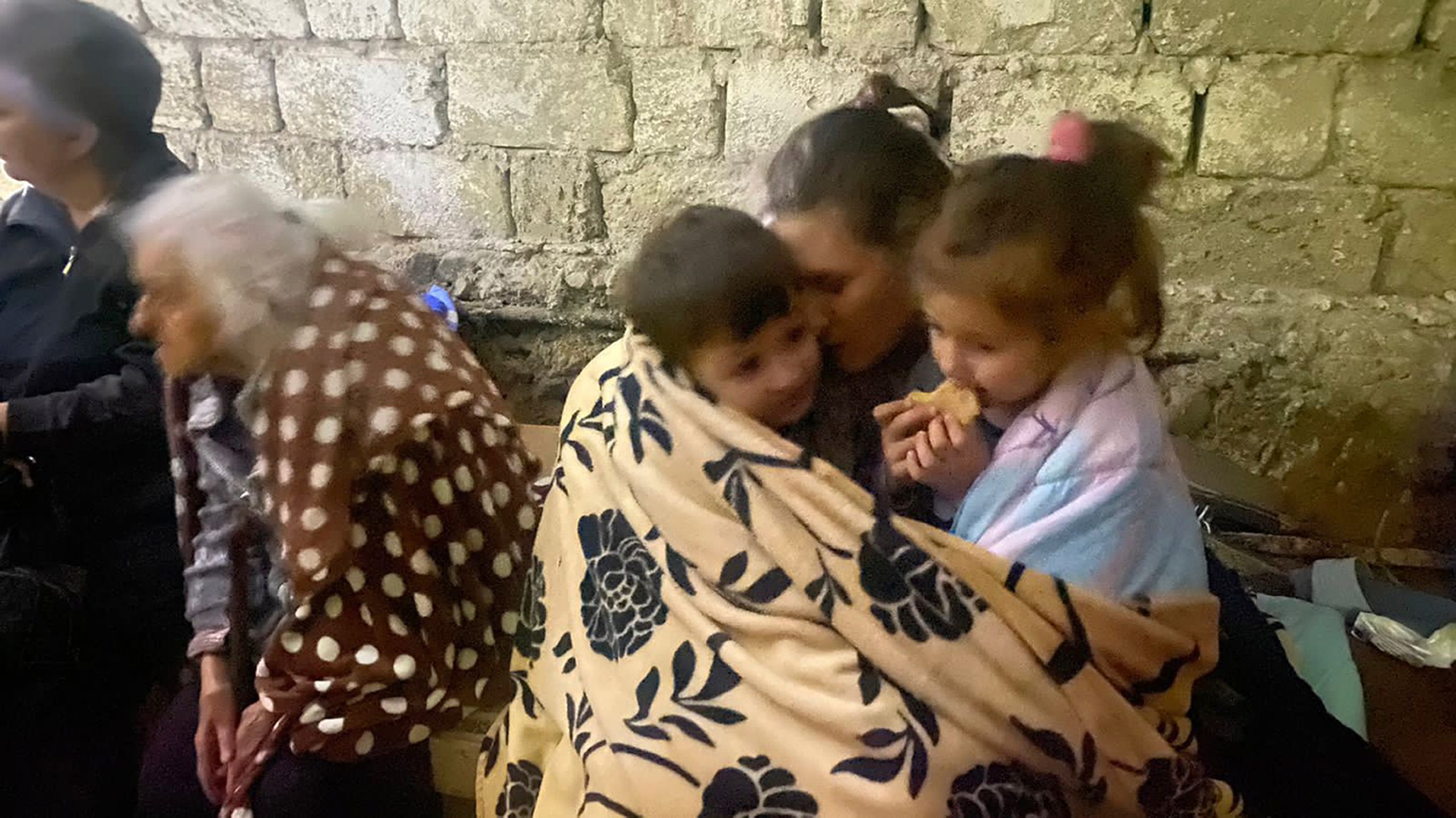 Children eat sitting in a shelter during shelling in Stepanakert in Nagorno-Karabakh. Azerbaijan on Tuesday declared that it started what it called an "anti-terrorist operation" targeting Armenian military positions in the Nagorno-Karabakh region and officials in that region said there was heavy artillery firing around its capital. (AP Photo/Siranush Sargsyan)