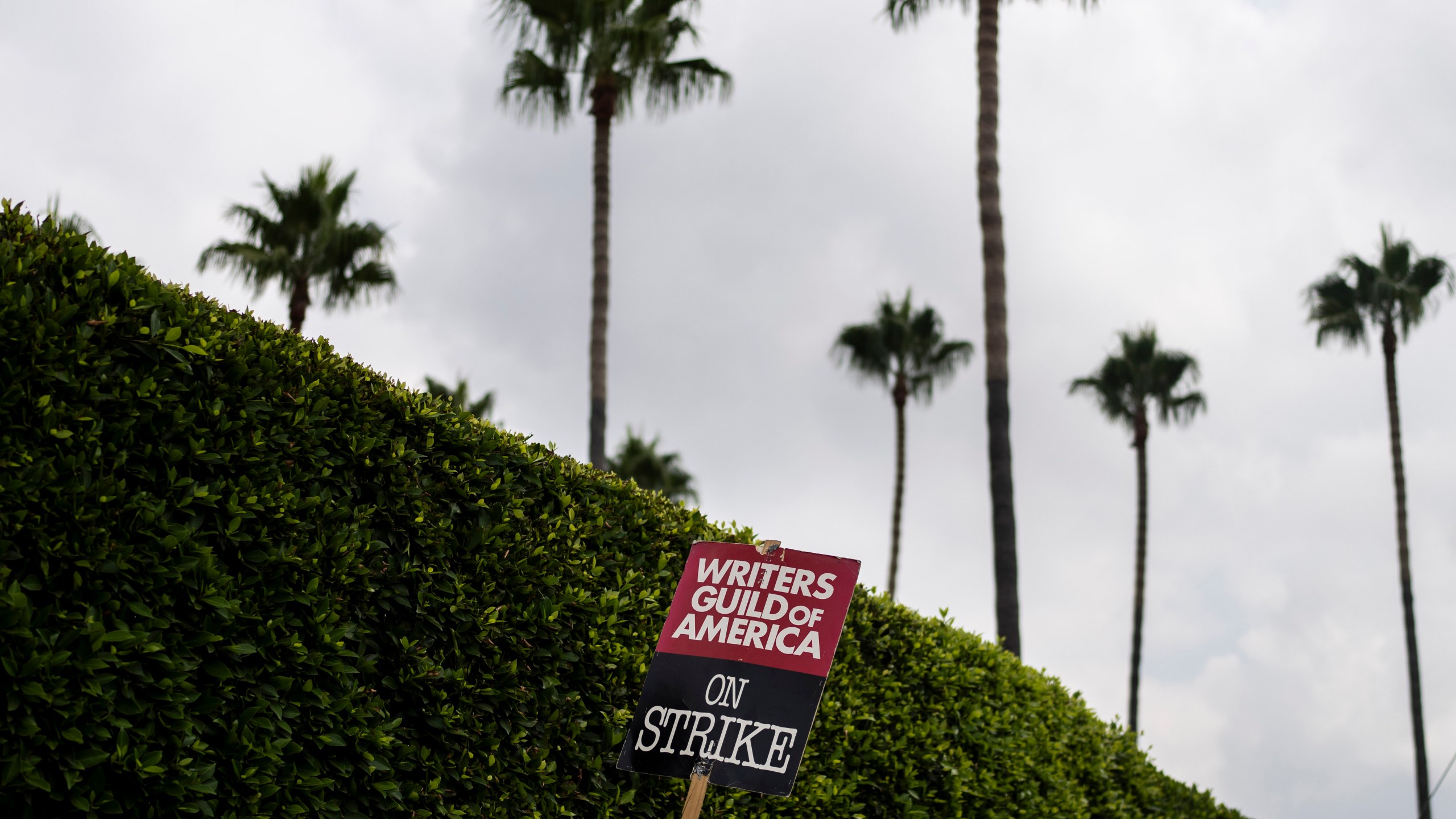 FILE - A demonstrator holds up a sign during a rally outside the Paramount Pictures Studio in Los Angeles, Thursday, Sept. 21, 2023. On Sunday, Sept. 24, 2023, a tentative deal was reached to end Hollywood’s writers strike after nearly five months. (AP Photo/Jae C. Hong, File)