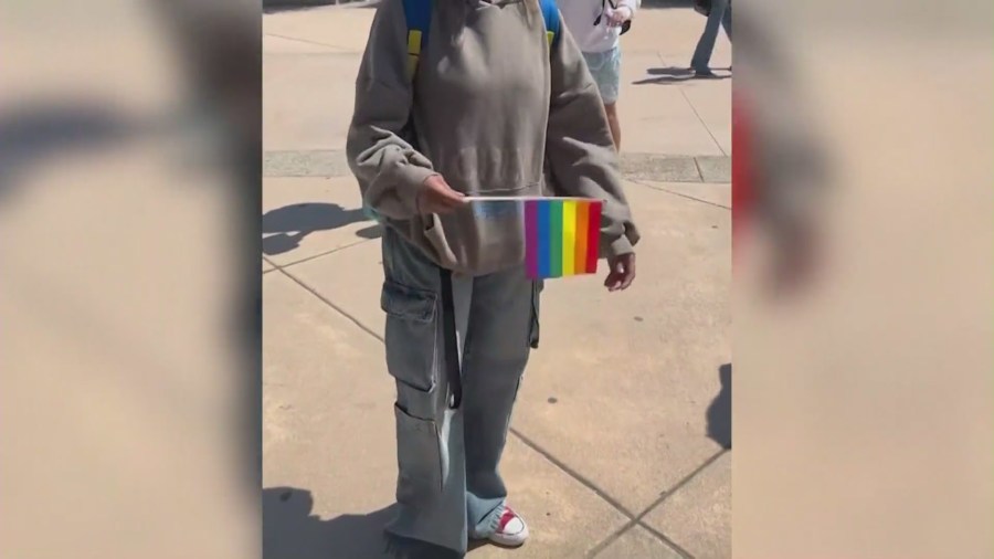 Pride flags being handed out by Moxxie, a 16-year-old high school student in Temecula, to his classmates in protest of the school district’s flag ban policy. (Moxxie)