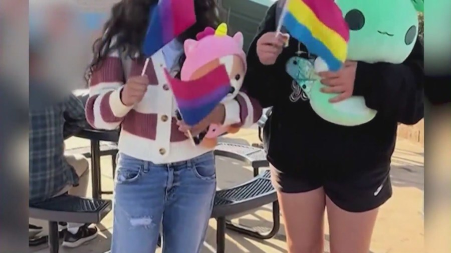 Pride flags being handed out by Moxxie, a 16-year-old high school student in Temecula, to his classmates in protest of the school district’s flag ban policy. (Moxxie)