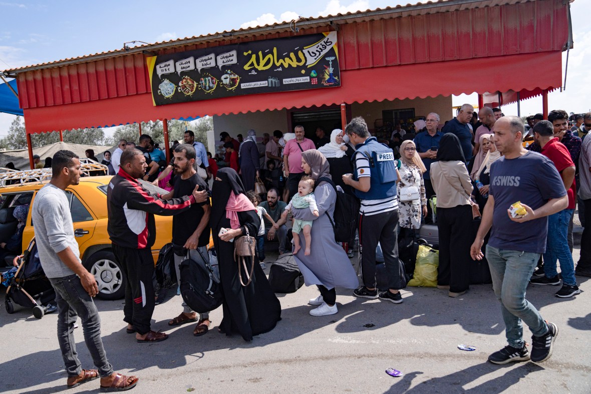 FILE - Palestinians wait to cross into Egypt at the Rafah border crossing in the Gaza Strip, Oct. 16, 2023. Former President Donald Trump and other top Republicans are issuing increasingly urgent calls for the U.S. to seal its borders against a potential mass exodus of Palestinians fleeing war in the Gaza Strip, suggesting that a surge in civilian refugees could allow potential extremists into the country. (AP Photo/Fatima Shbair, File)