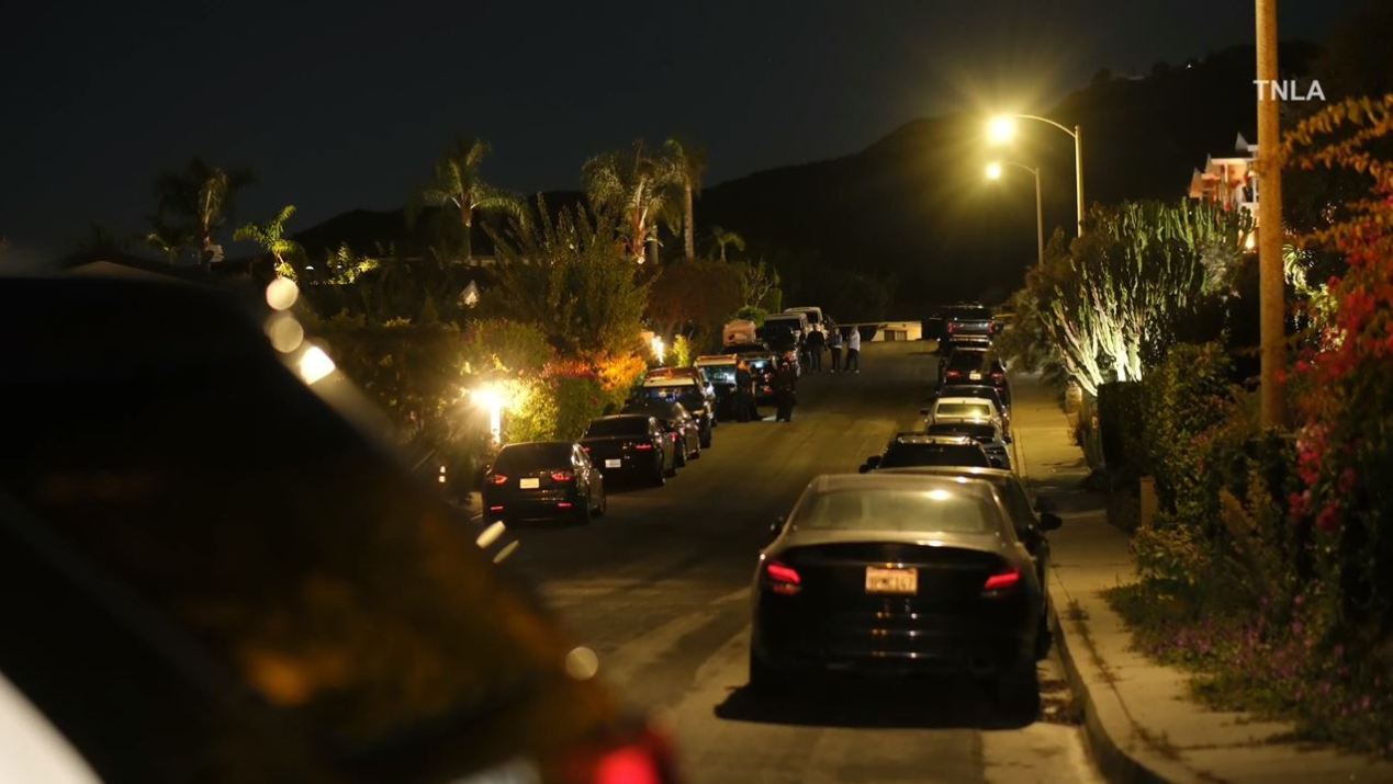 Law enforcement and loved ones arrive at Matthew Perry's Pacific Palisades home following news of the actor's death on Oct. 28, 2023. (TNLA)