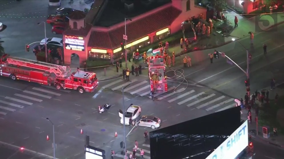 At least one person is hospitalized after a three-vehicle collision sent a truck crashing through a pizza shop in Hollywood on Oct. 31, 2023. (KTLA)