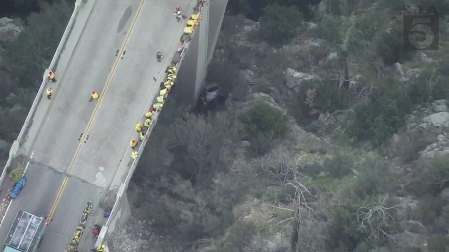 A trapped driver was rescued by crews after crashing off the side of a bridge in the Angeles National Forest on Oct. 6, 2023. (KTLA)