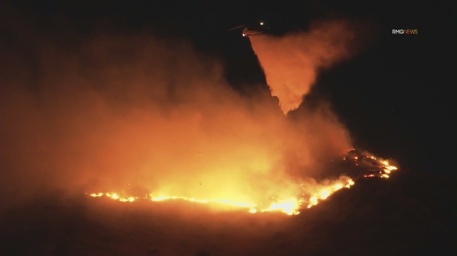 Fire crews work to contain overnight brush fire in San Fernando Valley amid Santa Ana winds 