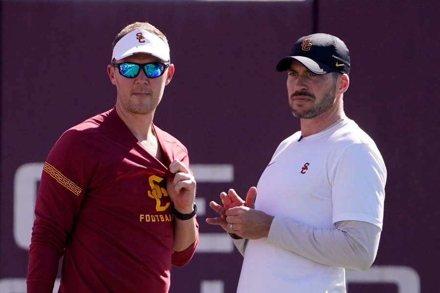 FILE - Southern California head coach Lincoln Riley, left, talks with defensive coordinator Alex Grinch during an NCAA college football practice Thursday, March 24, 2022, in Los Angeles. Southern California fired defensive coordinator Alex Grinch Sunday, Nov. 5, 2023, with two games left in the Trojans' disappointing regular season.(AP Photo/Mark J. Terrill, File)