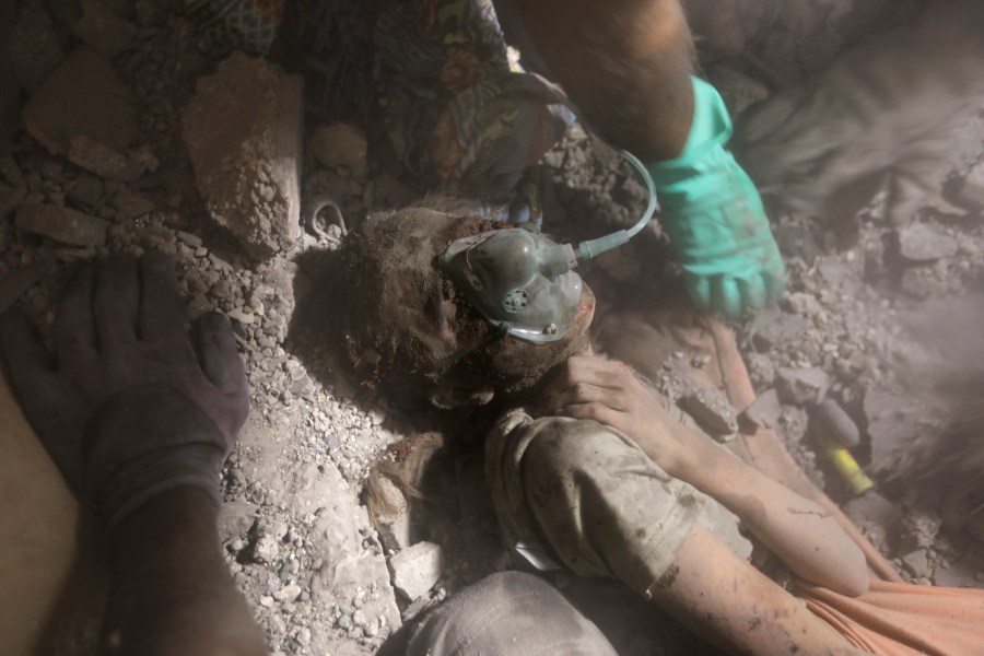 Palestinians rescue a wounded girl from under the rubble of a destroyed building following an Israeli airstrike in Khan Younis refugee camp, southern Gaza Strip, Tuesday, Nov. 7, 2023. (AP Photo/Mohammed Dahman)