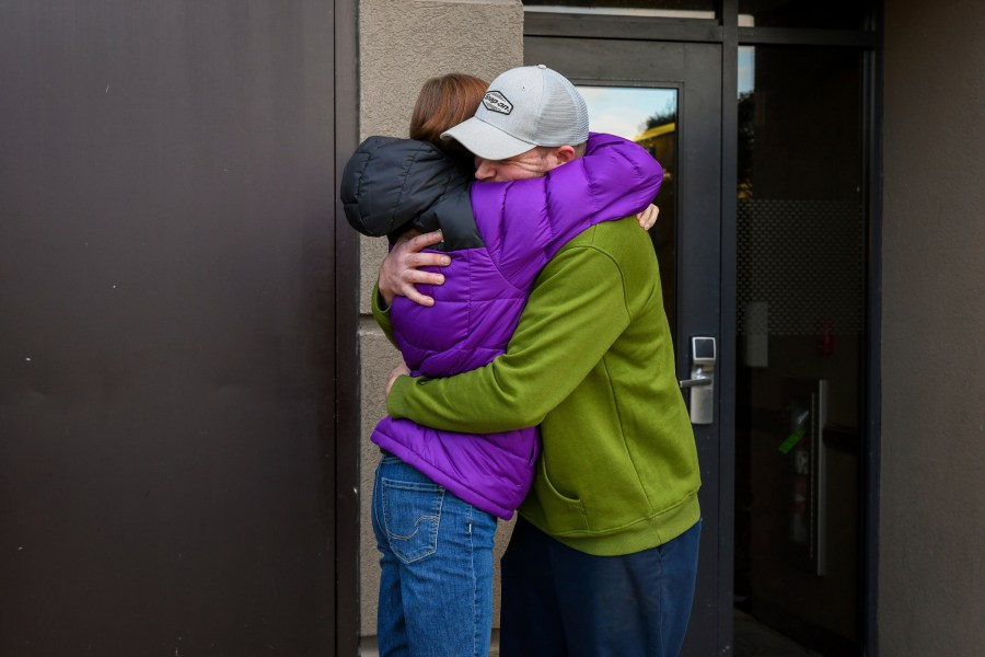 Alexandria Johnson, 35, embraces her fiance, Greg Fennell, 42, as he departs for work, Thursday, November 2, 2023, in Oneonta, N.Y. Johnson filed separate lawsuits against New York City and the state corrections department under the Adult Survivors Act, alleging repeated sexual assaults while she was incarcerated at Rikers Island, as well as at the state's Bedford Hills facility that led to the termination of her pregnancy. "I had to take a chance that there would be justice," said Johnson, of her decision to file the law suits. (AP Photo/Heather Ainsworth)