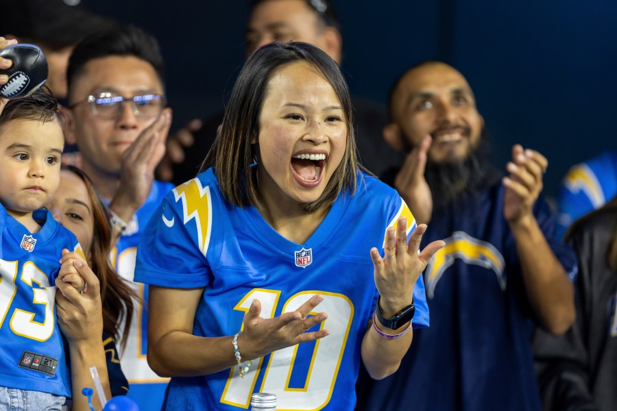 Los Angeles Chargers fan Merianne Do cheers for the Chargers while the Chargers play against the Chicago Bears in an NFL football game, Sunday, Oct. 29, 2023, in Inglewood, Calif. Chargers defeated the Bears 30-13. (AP Photo/Jeff Lewis)