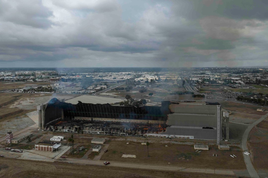 A historic blimp hangar burns in Tustin, Calif., Tuesday, Nov. 7, 2023. A fire destroyed a massive World War II-era wooden hangar that was built to house military blimps based in Southern California. (AP Photo/Jae C. Hong)