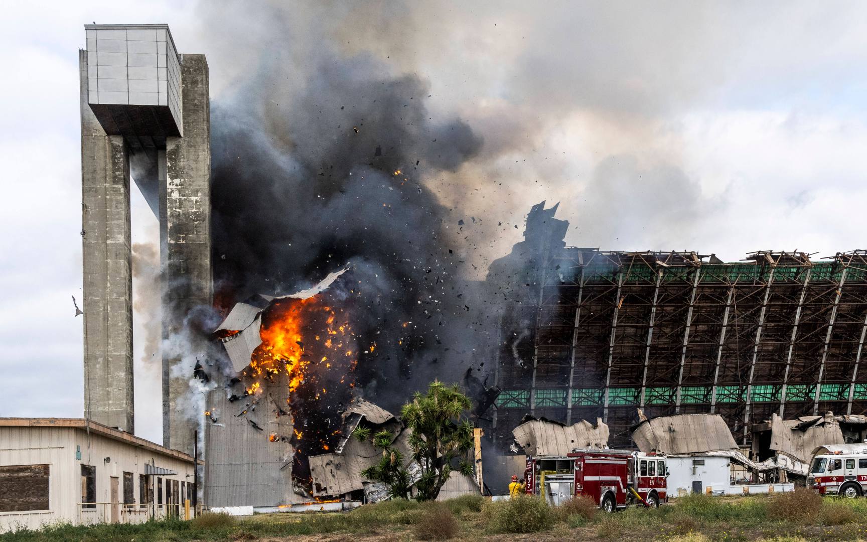 Orange County firefighters battle a fire affecting the north hangar at the Tustin Air Base in Tustin, Calif. Tuesday, Nov. 7, 2023. (Paul Bersebach/The Orange County Register via AP)