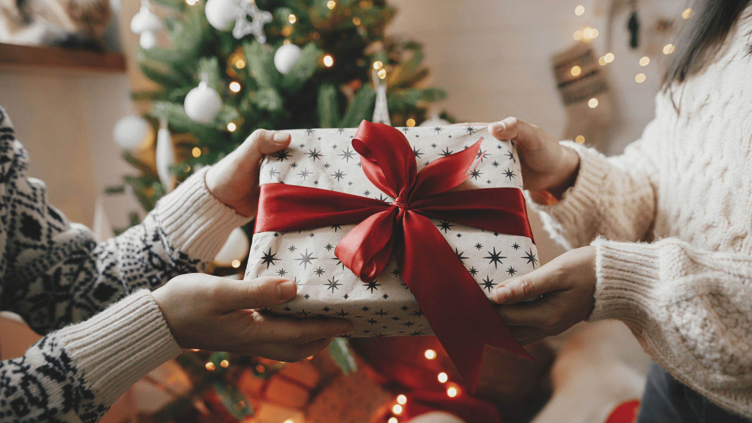 A couple exchanges a Christmas gift.