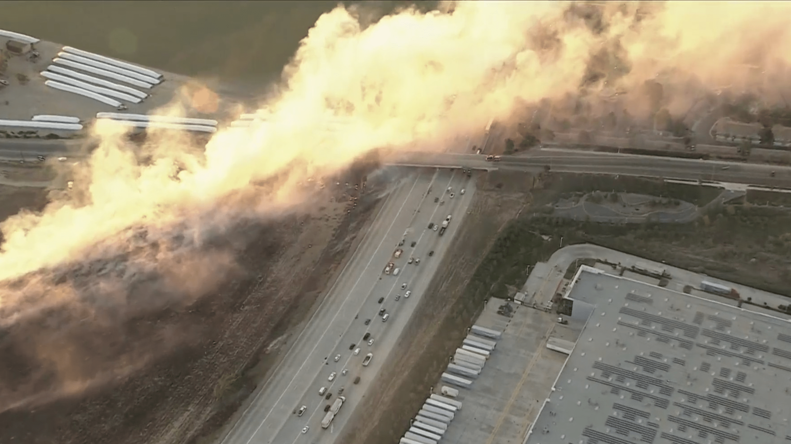 Fire burns along the 15 Freeway in Jurupa Valley.