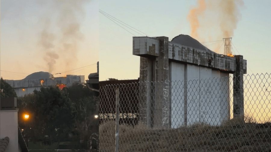 An active flare-up of a fire seen on the doors of a historic airbase hangar in Tustin on Nov. 11 has prompted concerns from residents. (gingersnapssocal)