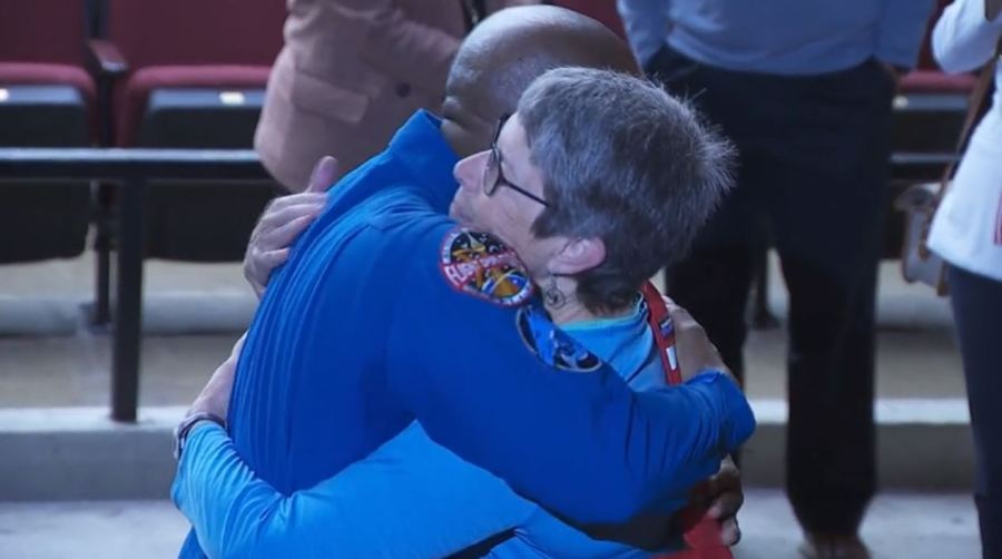 NASA astronaut Victor Glover reunites with Robin Ikeda, his former biology teacher, at Ontario High School on Nov. 17, 2023. (KTLA)