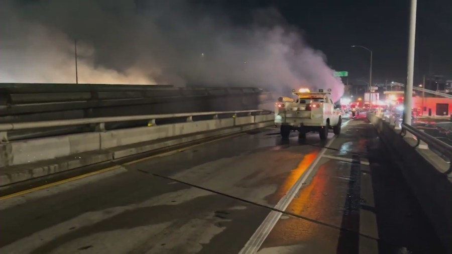 Firefighters battle a fire near an overpass in downtown Los Angeles on Nov. 11, 2023. (KTLA)