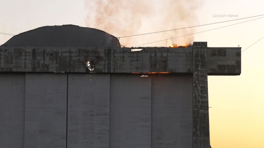 An active flare-up of a fire seen on the doors of a historic airbase hangar in Tustin on Nov. 11 has prompted concerns from residents. (County News)