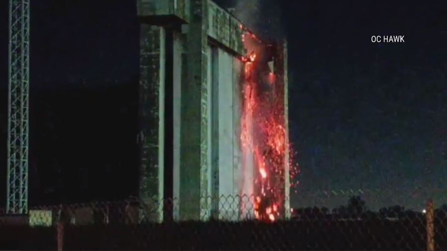 An active flare-up of a fire seen on the doors of a historic airbase hangar in Tustin on Nov. 11 has prompted concerns from residents. (OC Hawk)