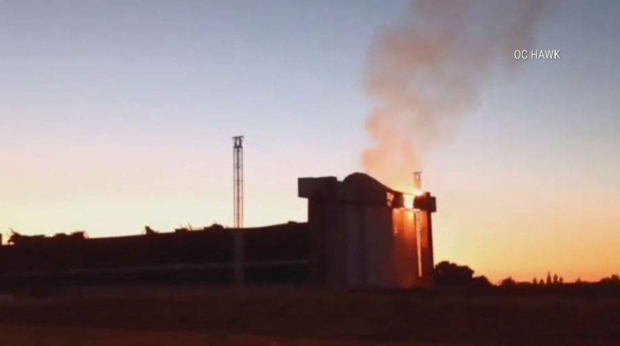 An active flare-up of a fire seen on the doors of a historic airbase hangar in Tustin on Nov. 11 has prompted concerns from residents. (OC Hawk)