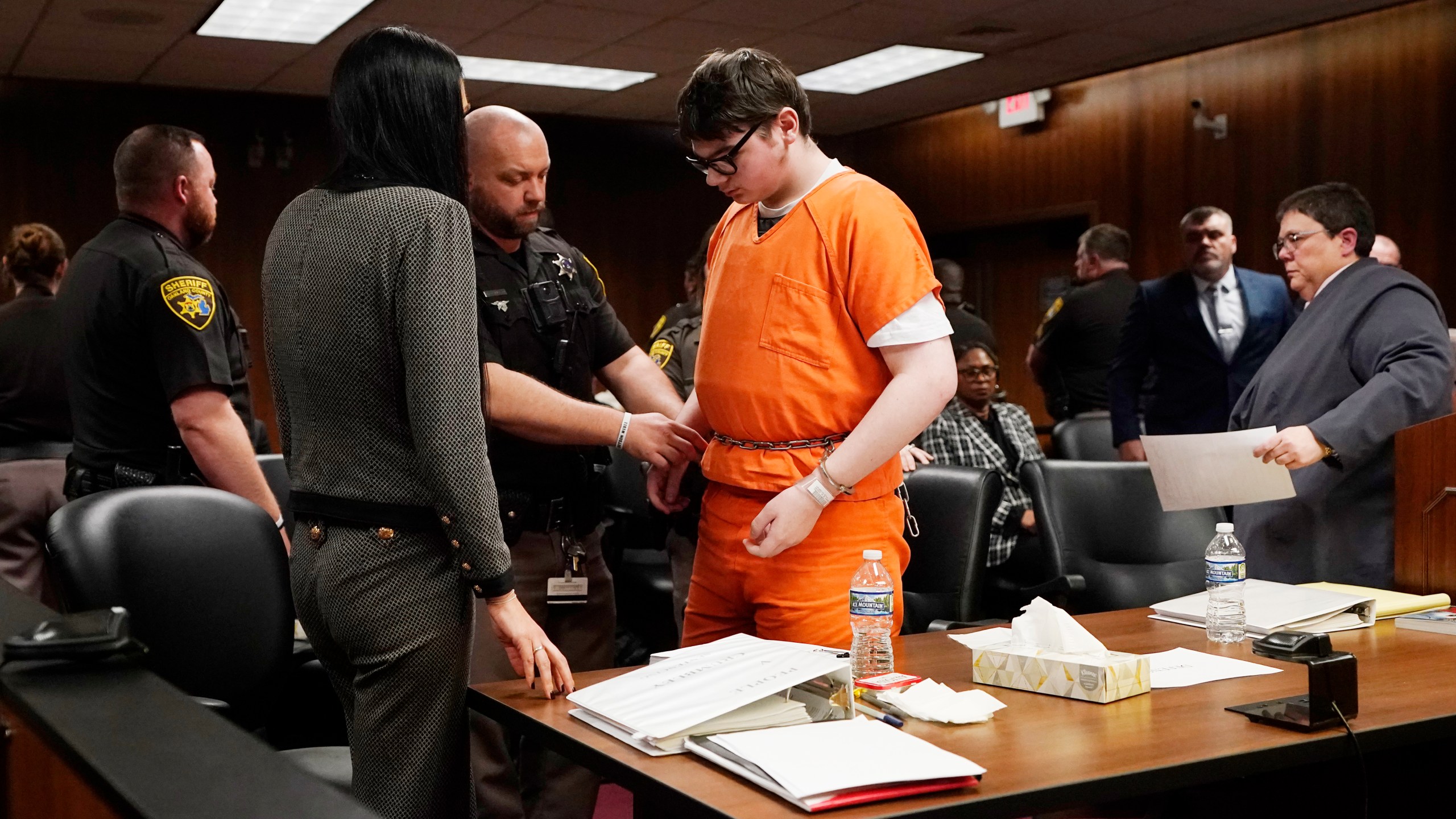 Ethan Crumbly is escorted by sheriff deputies after being sentenced, Friday, Dec. 8, 2023, in Pontiac, Mich. Crumbly sentenced to life in prison for killing four students, wounding more and terrorizing Michigan's Oxford High School in 2021. A judge Friday rejected pleas for a shorter sentence and ensured that Crumbley, 17, will not get an opportunity for parole. (AP Photo/Carlos Osorio)