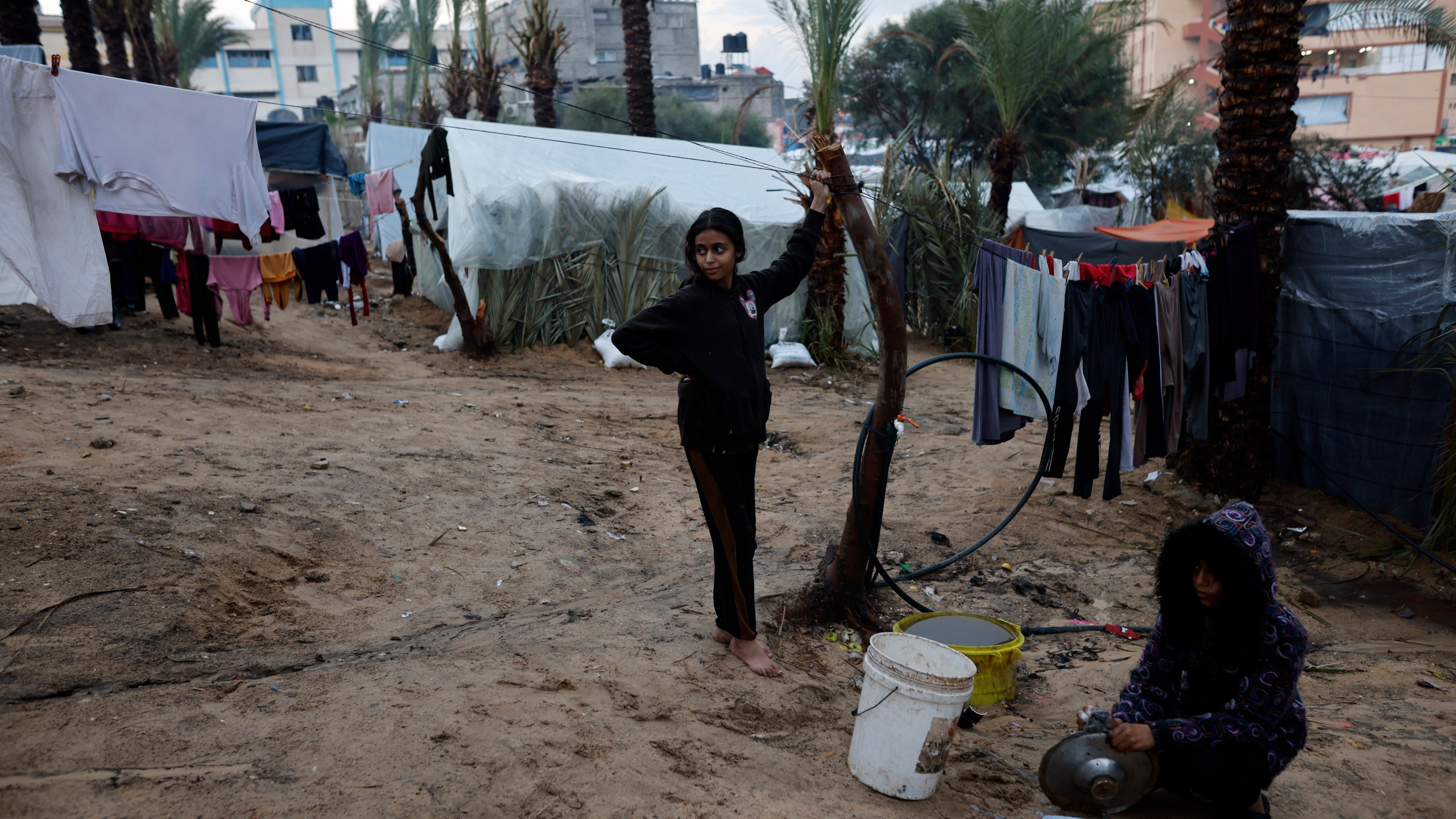 Palestinians displaced by the Israeli bombardment of the Gaza Strip are seen in tents in town of Khan Younis, Wednesday, Dec. 13, 2023. (AP Photo/Mohammed Dahman)