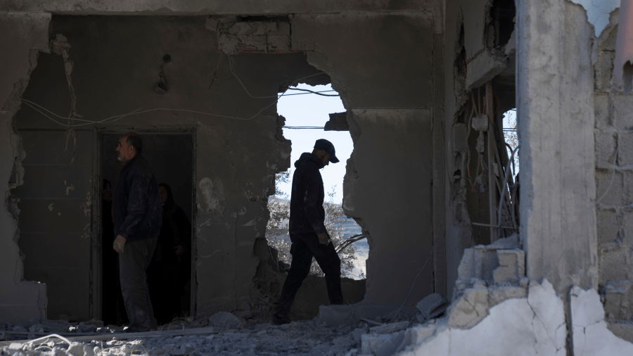 Palestinians inspect the destroyed apartment that belongs to Zeyad Safadi, in the West Bank village of Urif, near Nablus, Friday, Dec. 15, 2023.