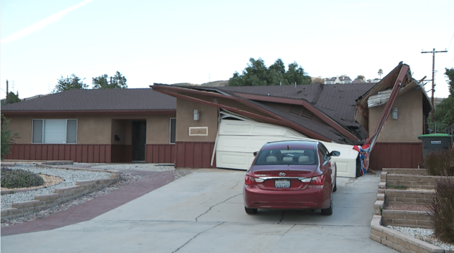 Toppled crane crushes portion of family's home