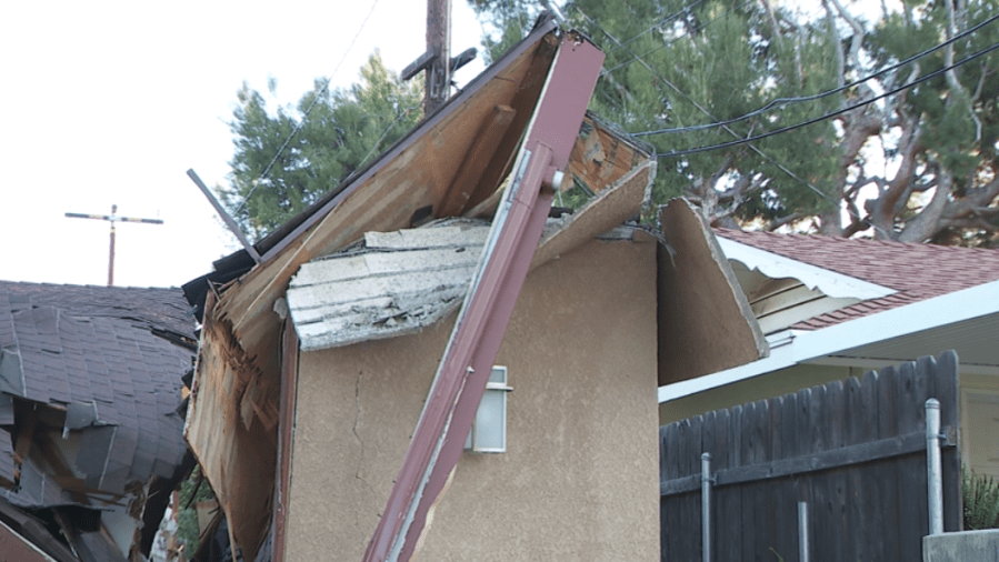 Toppled crane crushes portion of family's home