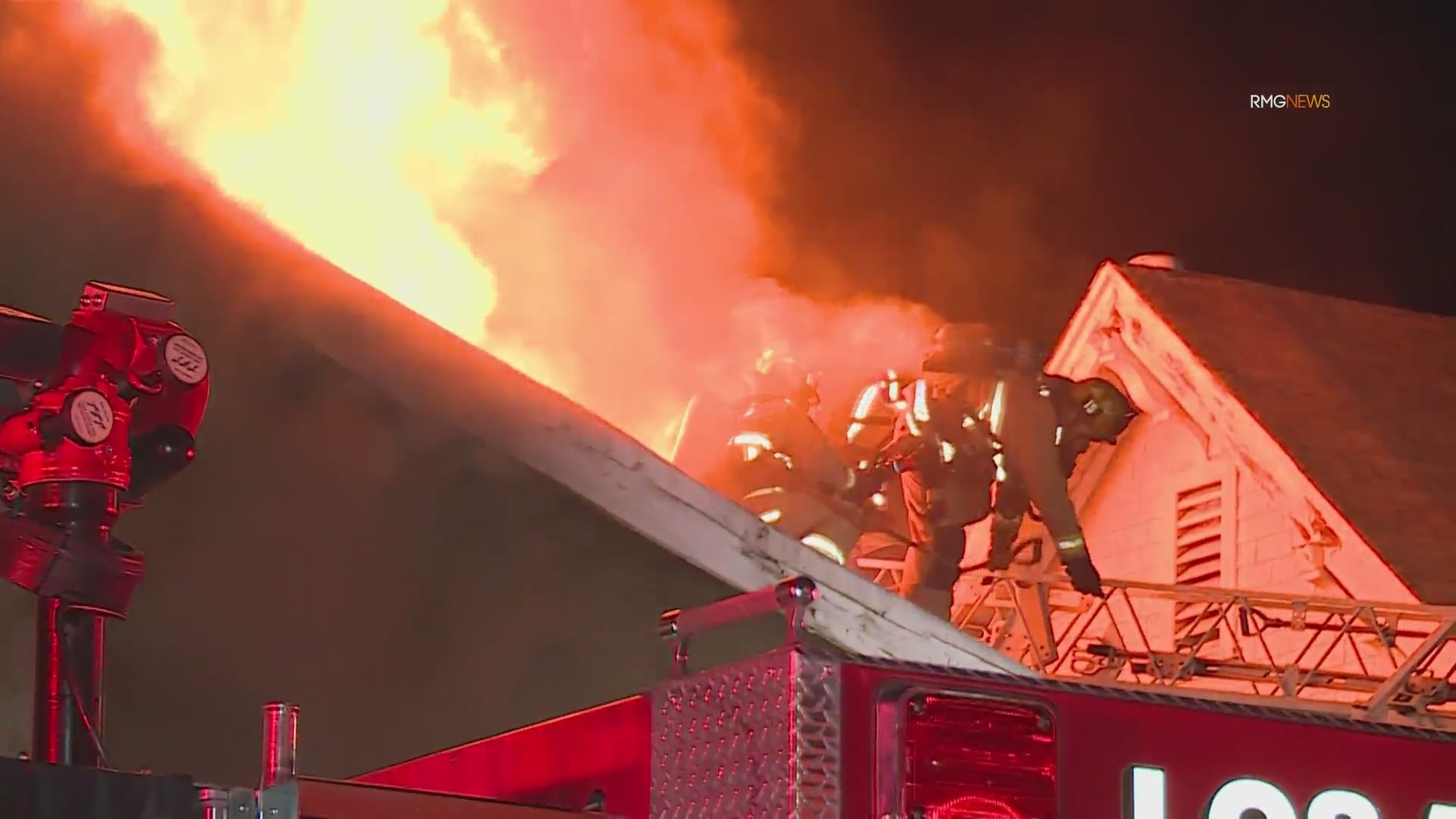 Video: Fire crews scramble to safety as fireball bursts through roof of home