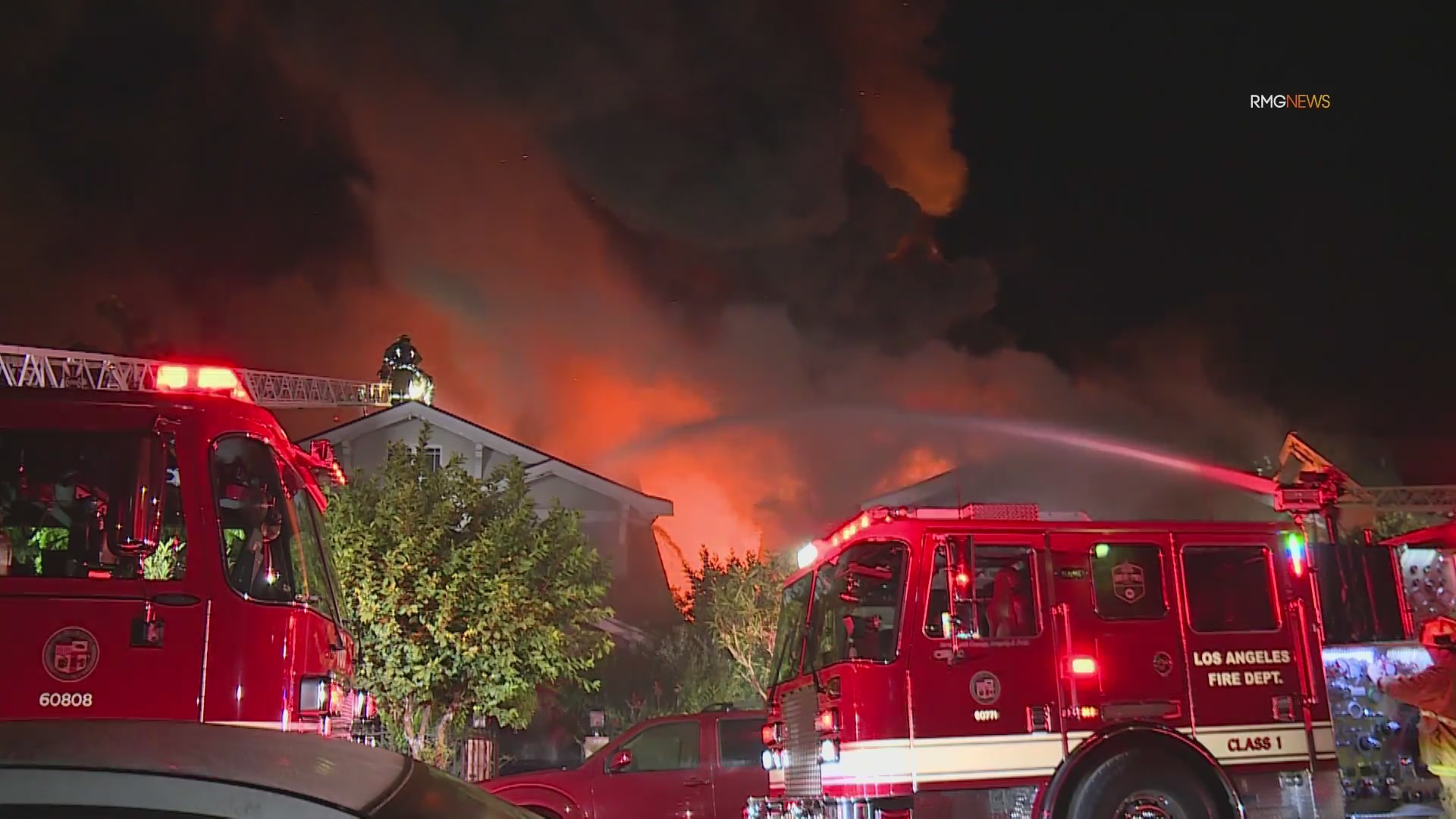 Video: Fire crews scramble to safety as fireball bursts through roof of home